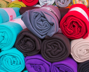 Rolled colorful fleece blankets