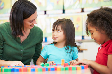 Elementary Pupils Counting With Teacher In Classroom