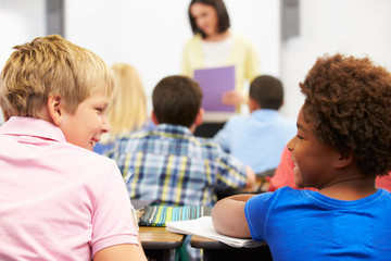 Two Pupils Talking In Class Together