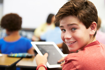 Fototapeta premium Pupil In Class Using Digital Tablet