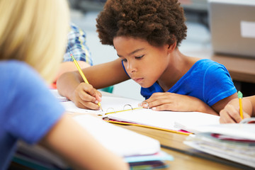 Pupils Studying At Desks In Classroom