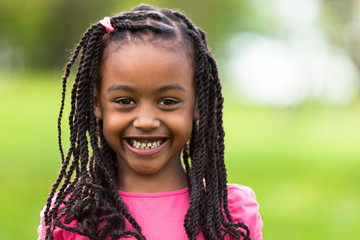 Outdoor close up portrait of a cute young black girl - African p - 52160393