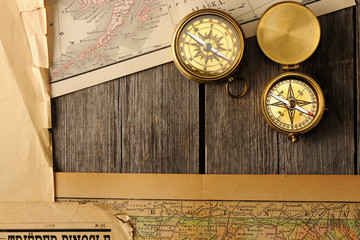 Fototapeta na wymiar Antique compasses over old map