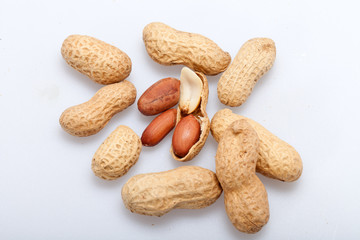 .Dried peanuts in closeup on the white background