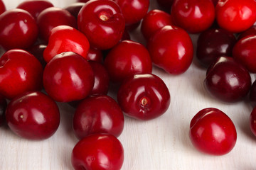 fresh cherry on white wooden table close-up