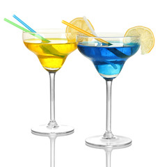 Yellow and blue cocktails in glasses isolated on white