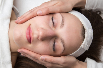Fototapeta na wymiar Cosmetician giving customer face massage