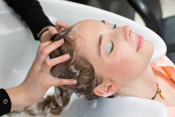 hairstylist washing customers hair