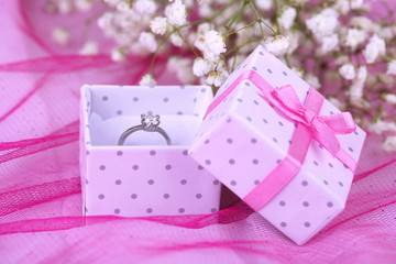 Fototapeta na wymiar engagement ring on pink cloth