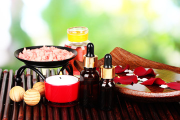 Spa composition with aroma oils on table on bright background