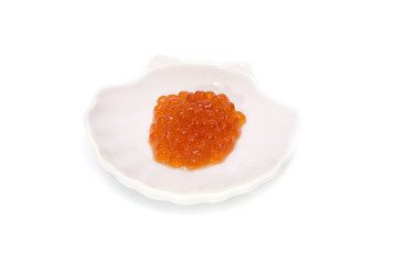 Red Caviar in shell saucer isolated on white