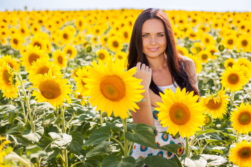 Beautiful young woman on the sunflowers field