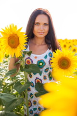 Beautiful young woman on the sunflowers field