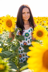 Beautiful young woman on the sunflowers field