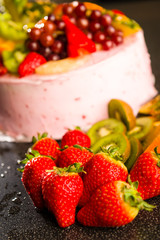 Fresh strawberries and kiwis with fruit cake