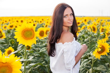 Beautiful young woman on the sunflowers field