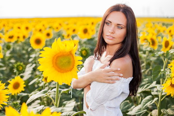 Beautiful young woman on the sunflowers field