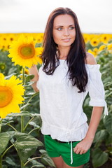 Beautiful young woman on the sunflowers field