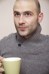 fashion portrait of handsome young man in a sweater