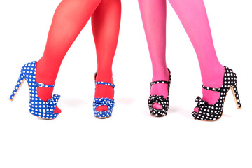Closeup of female legs in dotty heel shoes and vibrant stockings