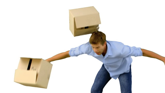Clumsy man dropping boxes over on white screen