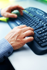 Fototapeta na wymiar Closeup image of male hands typing