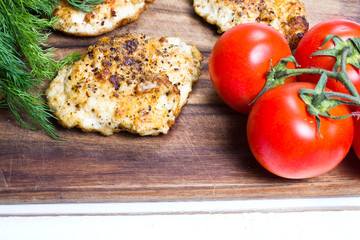 Grilled chicken breasts fillet with fresh vegetables closeup