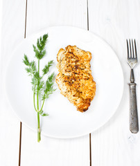 Grilled tasty chicken breasts on wooden background