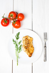 Grilled tasty chicken breasts on a white plate