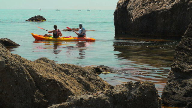 traveler kayaking in the Black sea from backward view