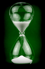 Hourglass on dark green background