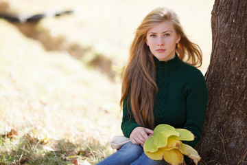 Beautiful young woman in autumn park