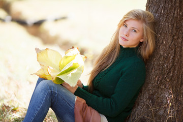 Beautiful young woman in autumn park