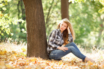 Beautiful young woman in autumn park