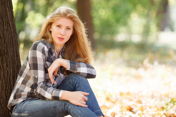 Beautiful young woman in autumn park