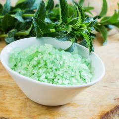 Sea salt in bowl on wooden background