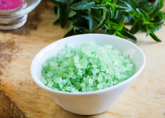 Sea salt in bowl on wooden background