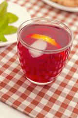 Fruit tea breakfast with cookies, lemon and peppermint.