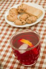 Fruit tea breakfast with cookies, lemon and peppermint.