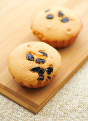 Small cupcake on wooden plate