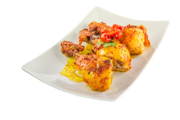 Tandoori chicken in a plate over white background