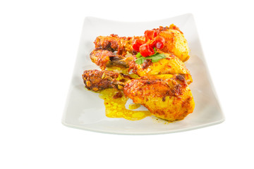 Tandoori chicken in a plate over white background