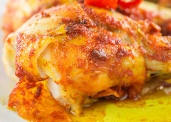 Tandoori chicken in a plate over white background