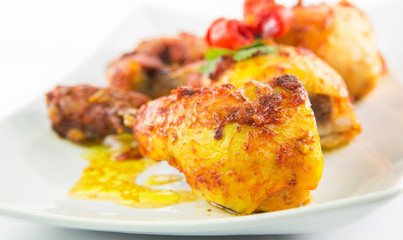 Tandoori chicken in a plate over white background