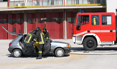 Naklejka premium Firefighters freed a wounded trapped in car after a traffic acci