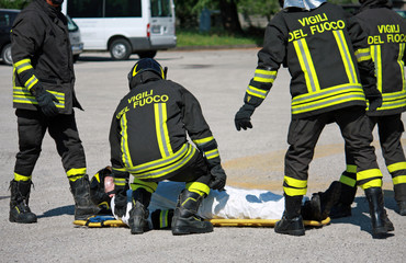 Firefighters carry a stretcher with serious injuries after the a
