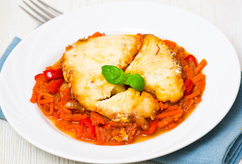 Roasted fish in tomato marinade with carrots and red pepper