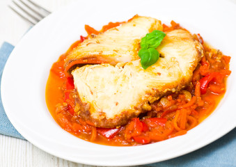 Roasted fish in tomato marinade with carrots and red pepper