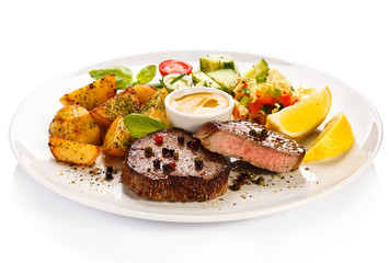 Grilled steak, baked potatoes and vegetables