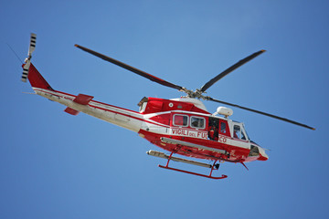 patrol helicopter of firefighters in blue sky over a fire 4